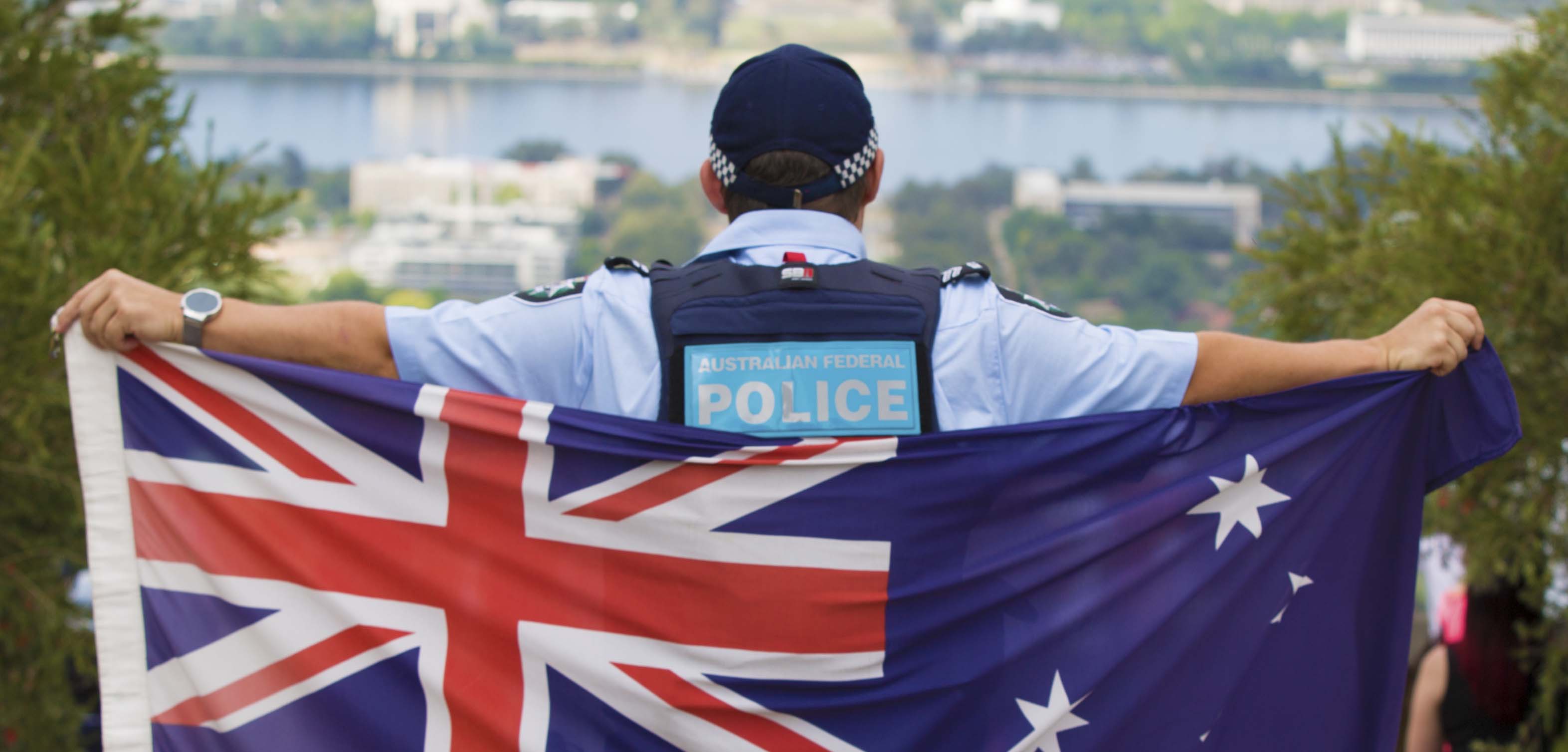 A police officer holding the Australian flag