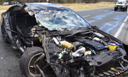 A Ford Falcon badly damaged in a collision on the Monaro Highway