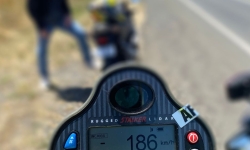 Motorcycle, rider, and speed reading of 186km/h