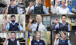 Image of nine police officers making an "OK" hand signal