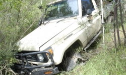 White Toyota Hilux stuck in bushland in Kowen Forest.